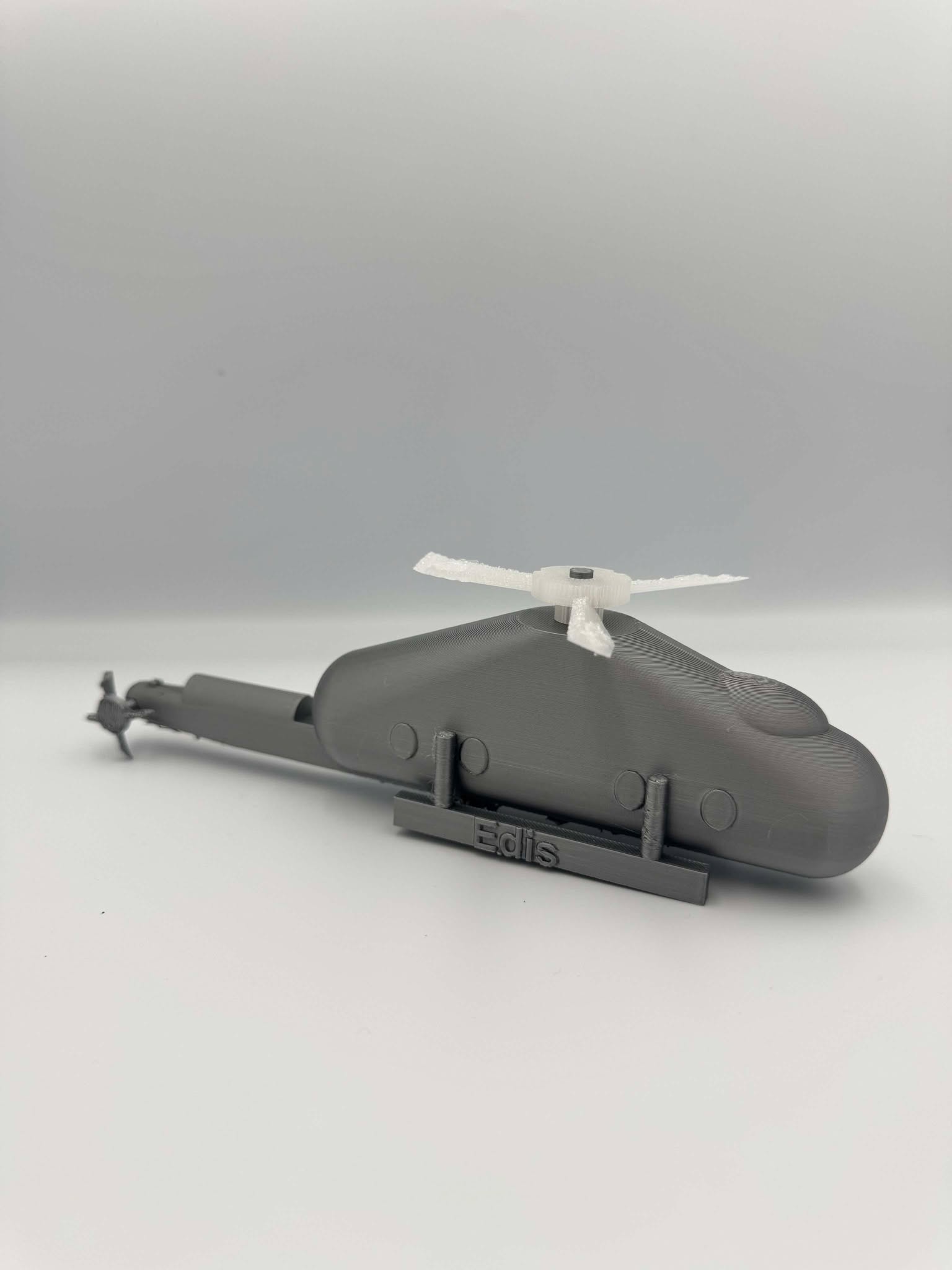 Helicopter An image of a 3D-printed helicopter model in a gray material.