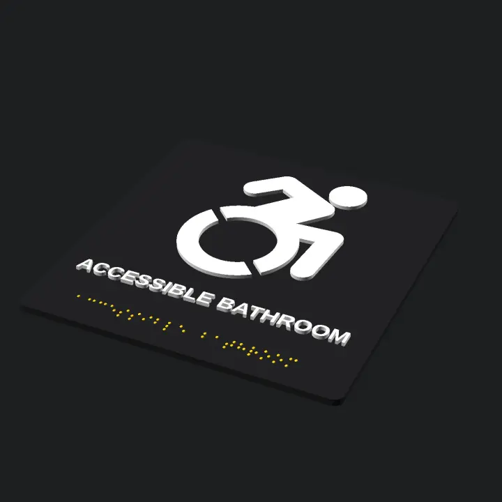 Three-quarter render of the black square bathroom sign with the white dynamic wheelchair symbol, raised text reading ACCESSIBLE BATHROOM, and a line of yellow braille dots below.
