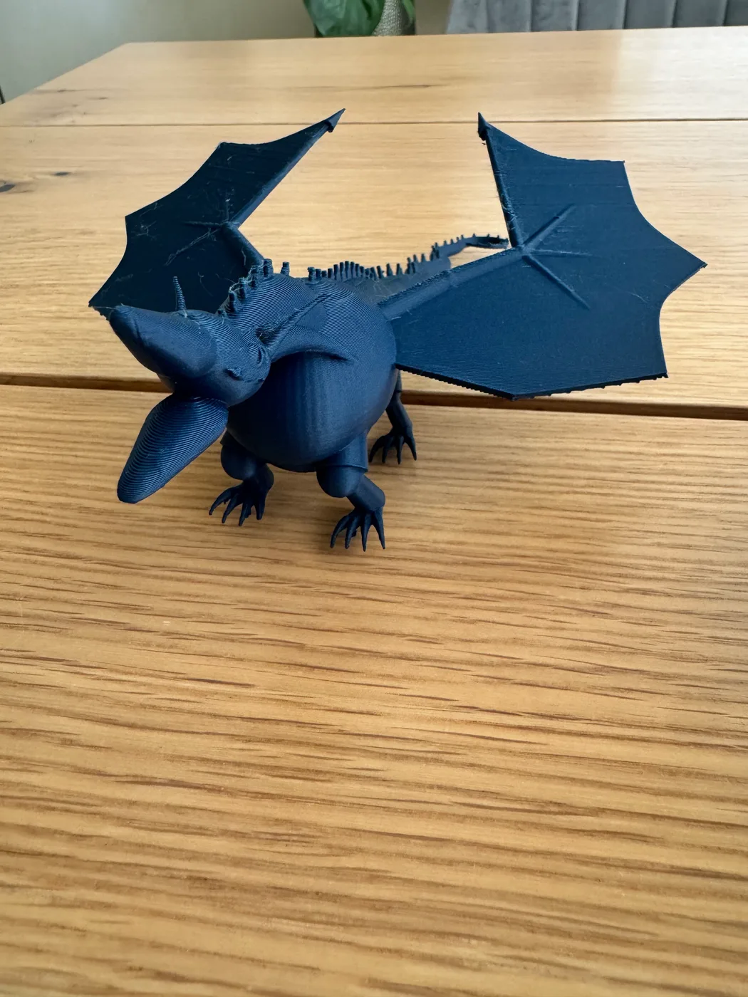 A matte PLA Shadow Wing dragon is shown with large fantasy wyvern wings, a curled tail, claws, horns and procedural design details.